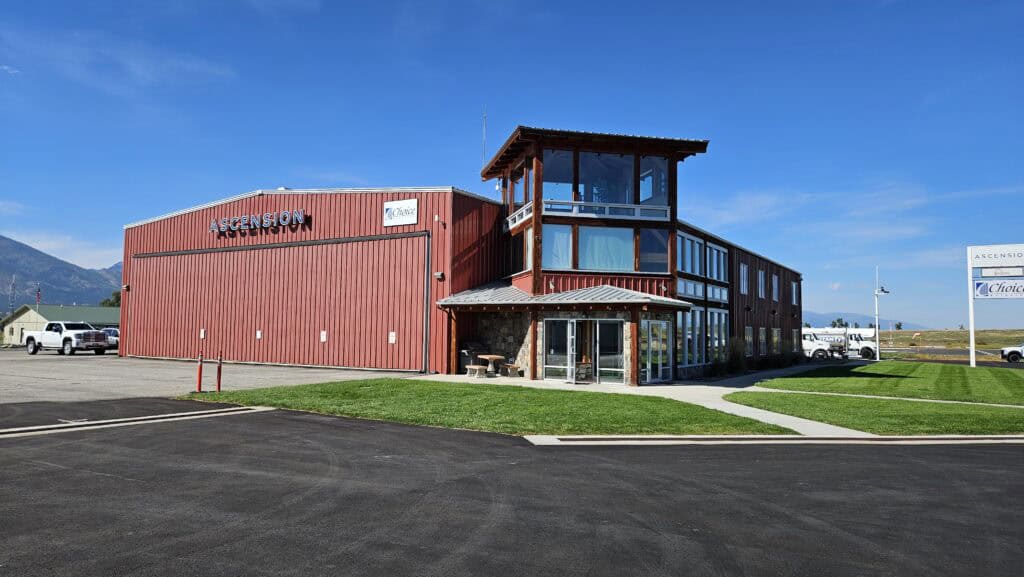 Choice Aviation's modern building with flight training and private charter services, located in a scenic area with mountains in the background.